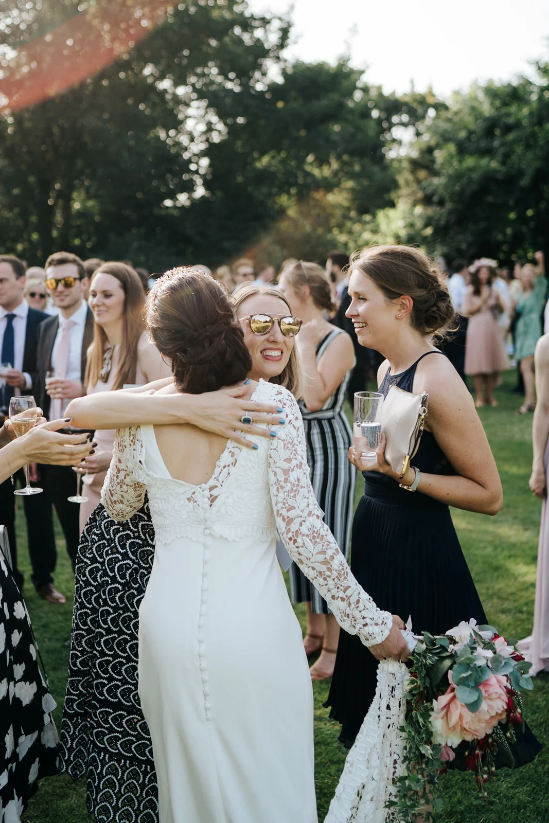 Bride receives hug from one of the guests during drinks ceremony