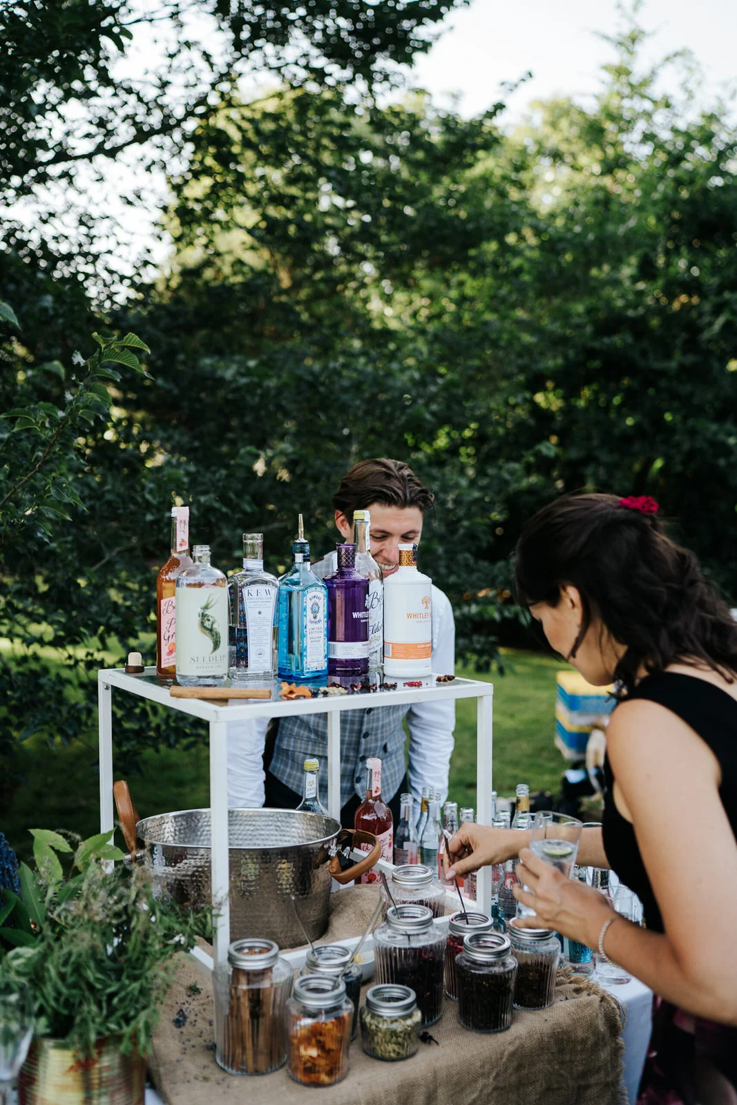 Guest prepares her own gin at pimp your gin stand during wedding drinks reception