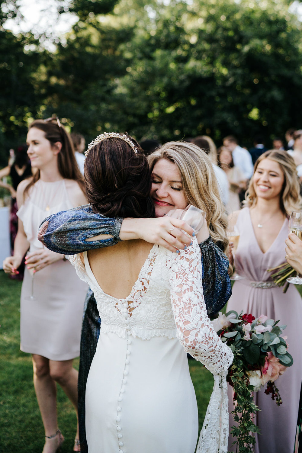  Bride receives hug from one of the guests during drinks ceremony 