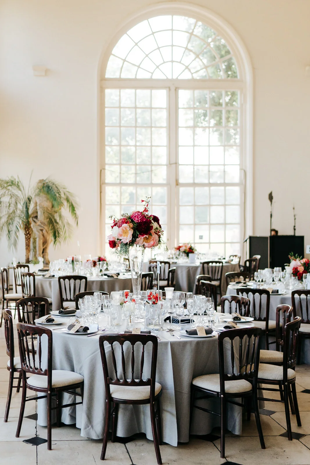 Wide shot of table setup for wedding breakfast at the orangery in kew gardens