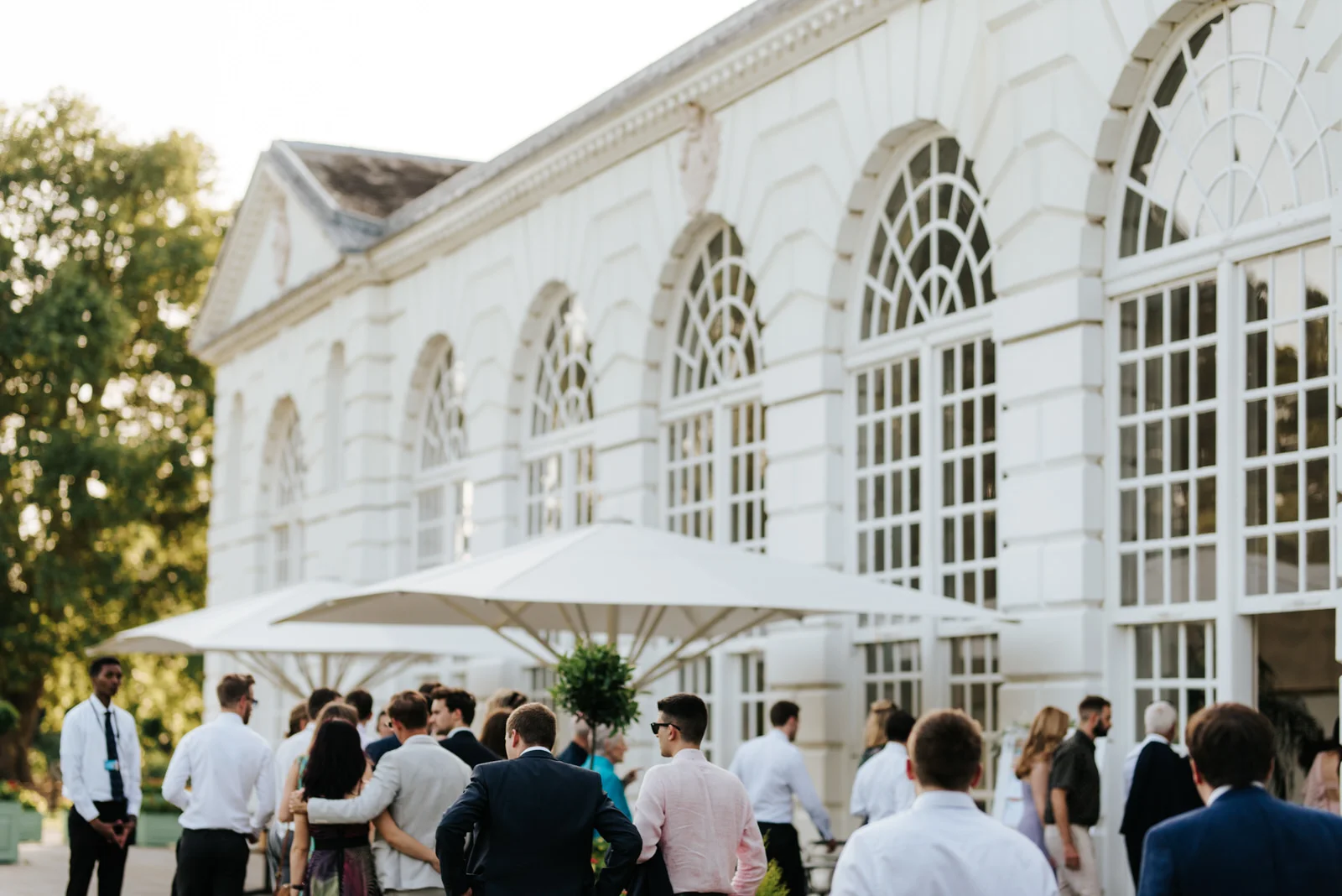 Guests make their way towards the orangery at kew gardens for the wedding breakfast
