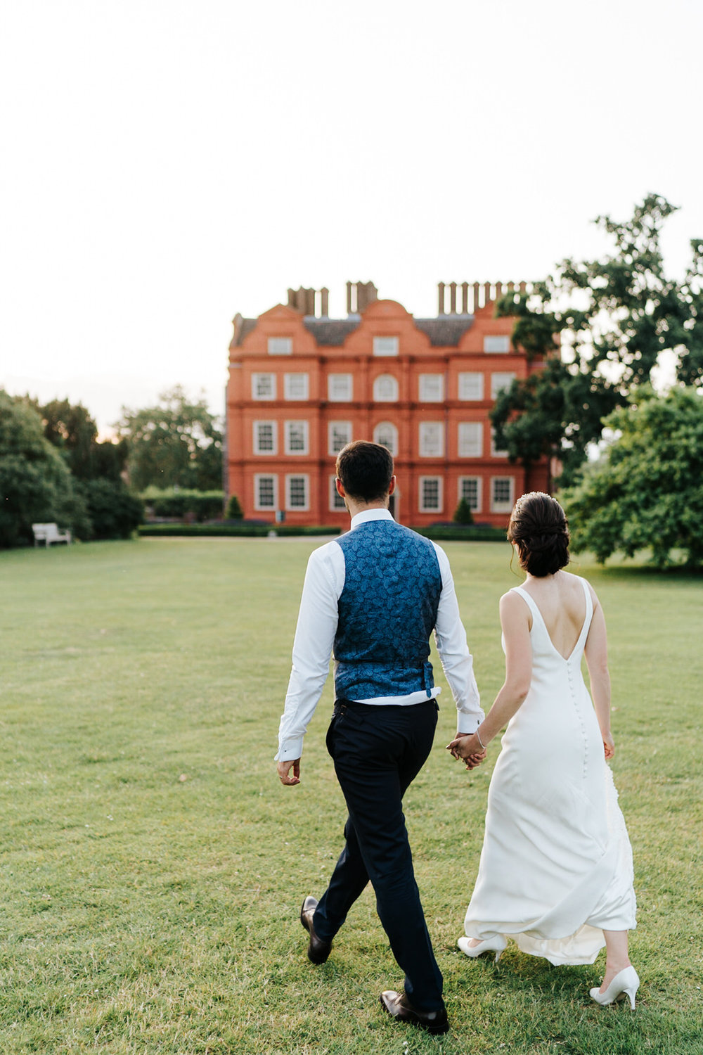  bride and groom go for a stroll around kew garden ground for couple photos 
