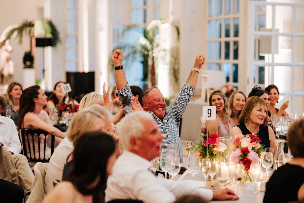  Guest reacts excitedly and throws hands into the air during speeches 