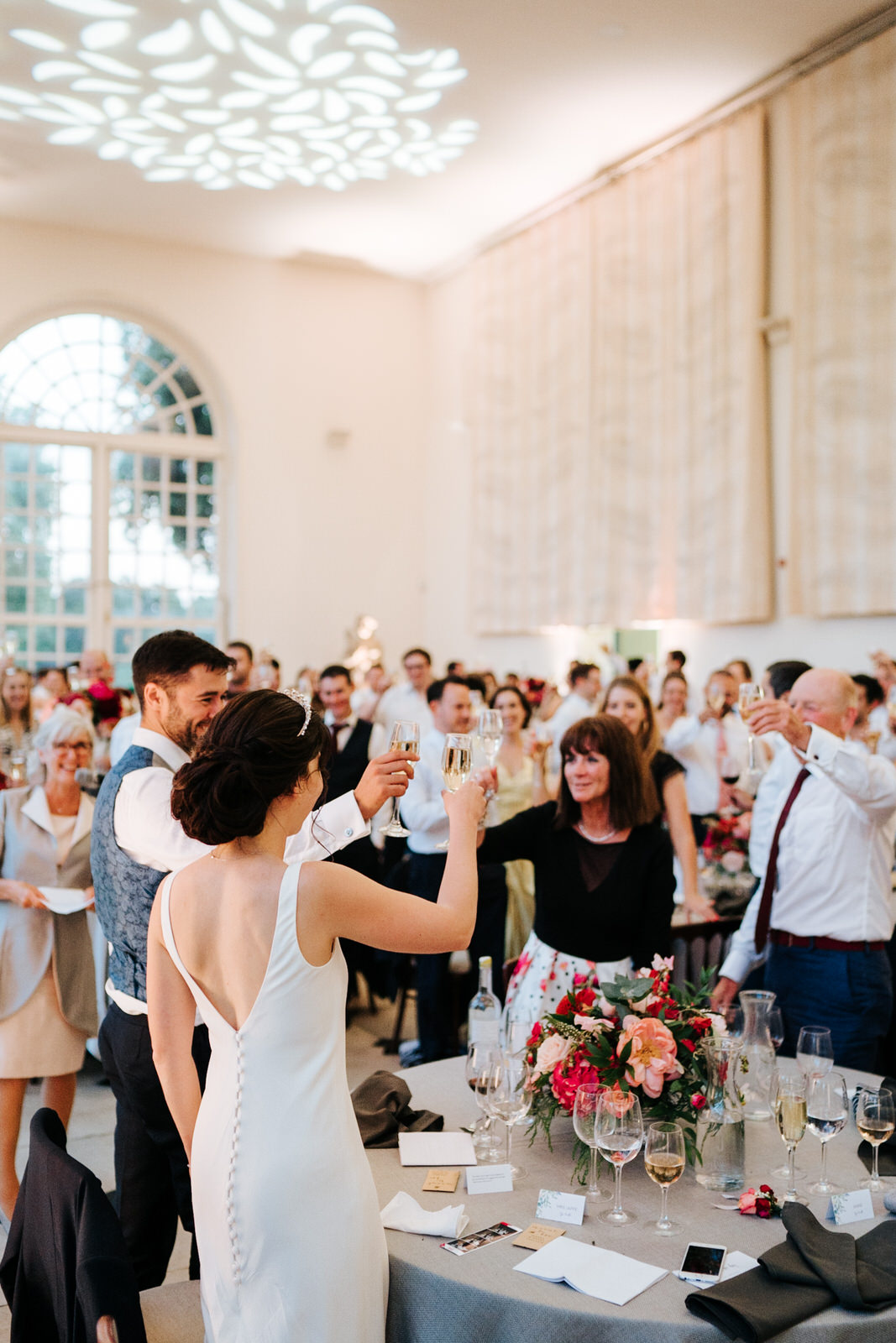  Bride and groom make a toast with all their guests as speech ends 