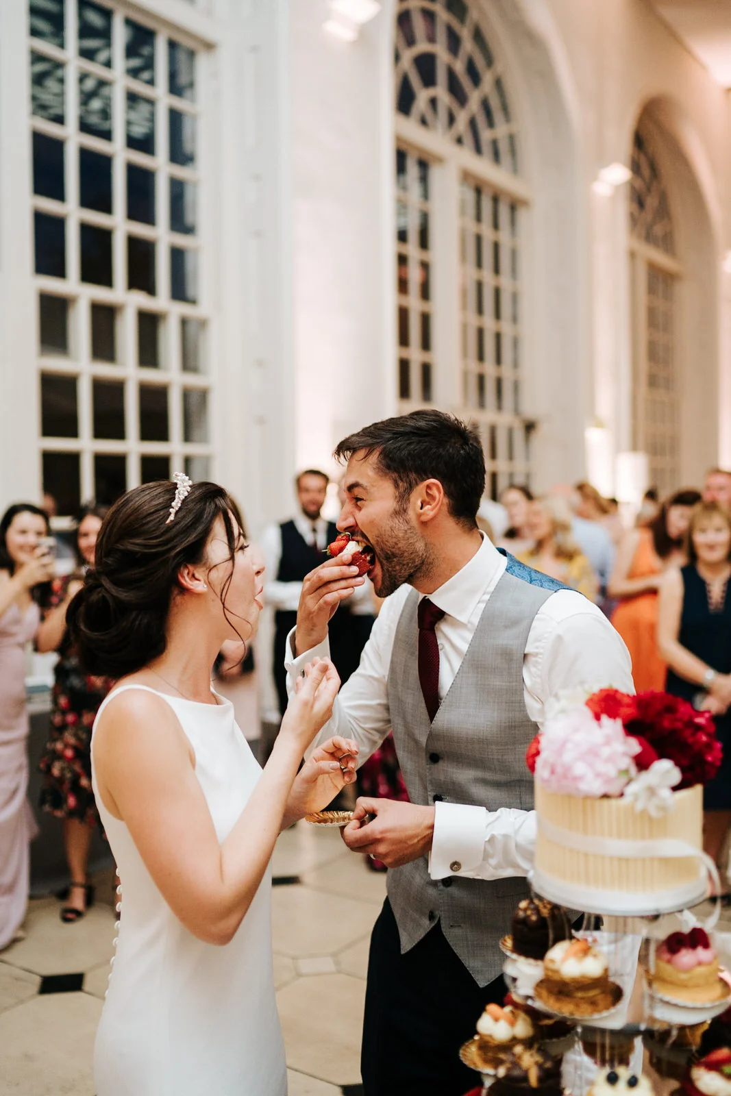 Bride and groom eat a slice of the wedding cake they just cut