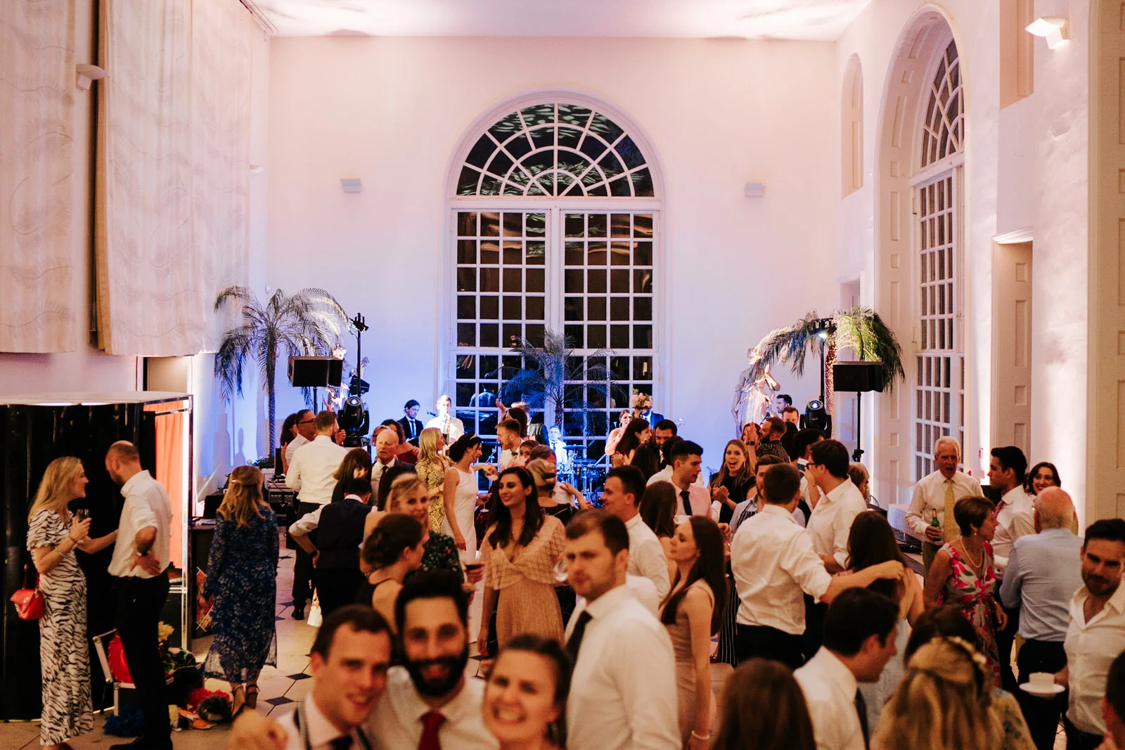 Wide photograph of guests on the dancefloor during the evening party at Nash Conservatory