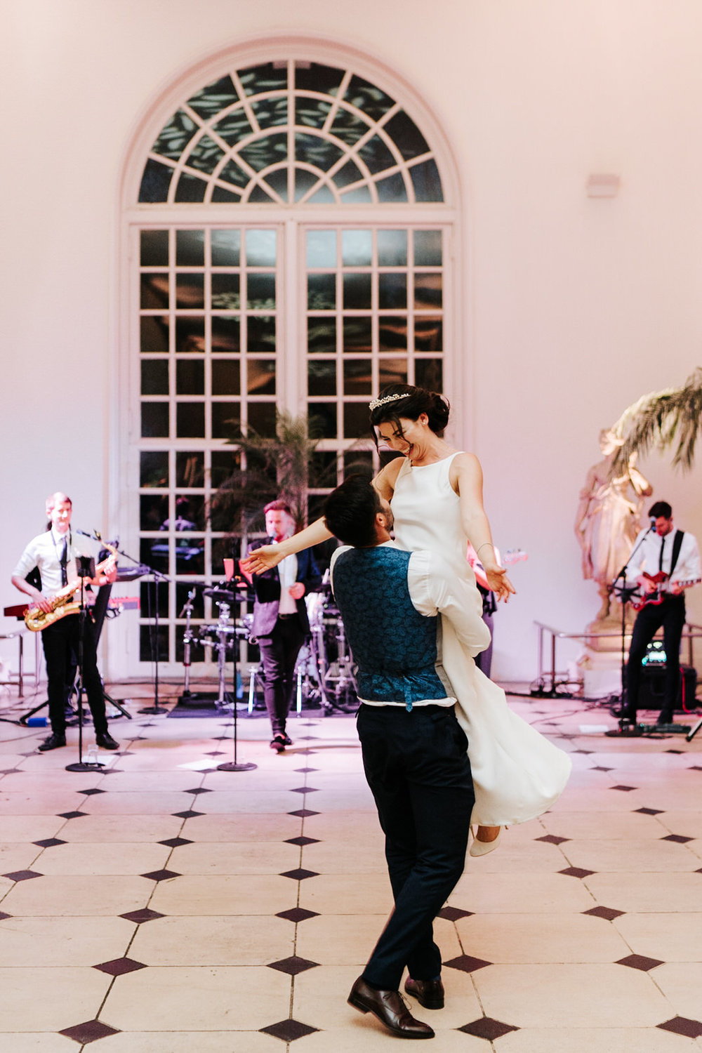  Groom lifts bride up and swings her around during first dance at Kew Gardens Nash Conservatory Wedding 