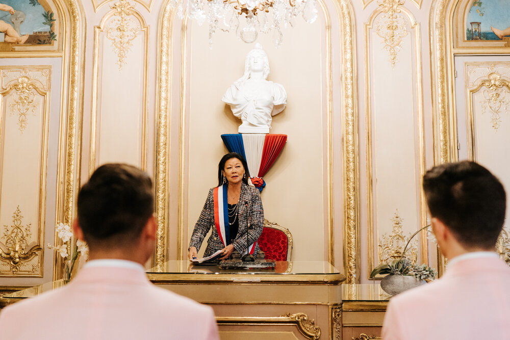  Mayor of Parisian district officiates the same sex wedding ceremony in a beautifully decorated room in Paris 
