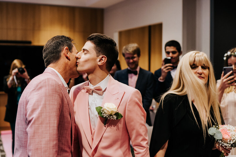  Groom kisses his father after walking to the front of the aisle at Paris same sex wedding 