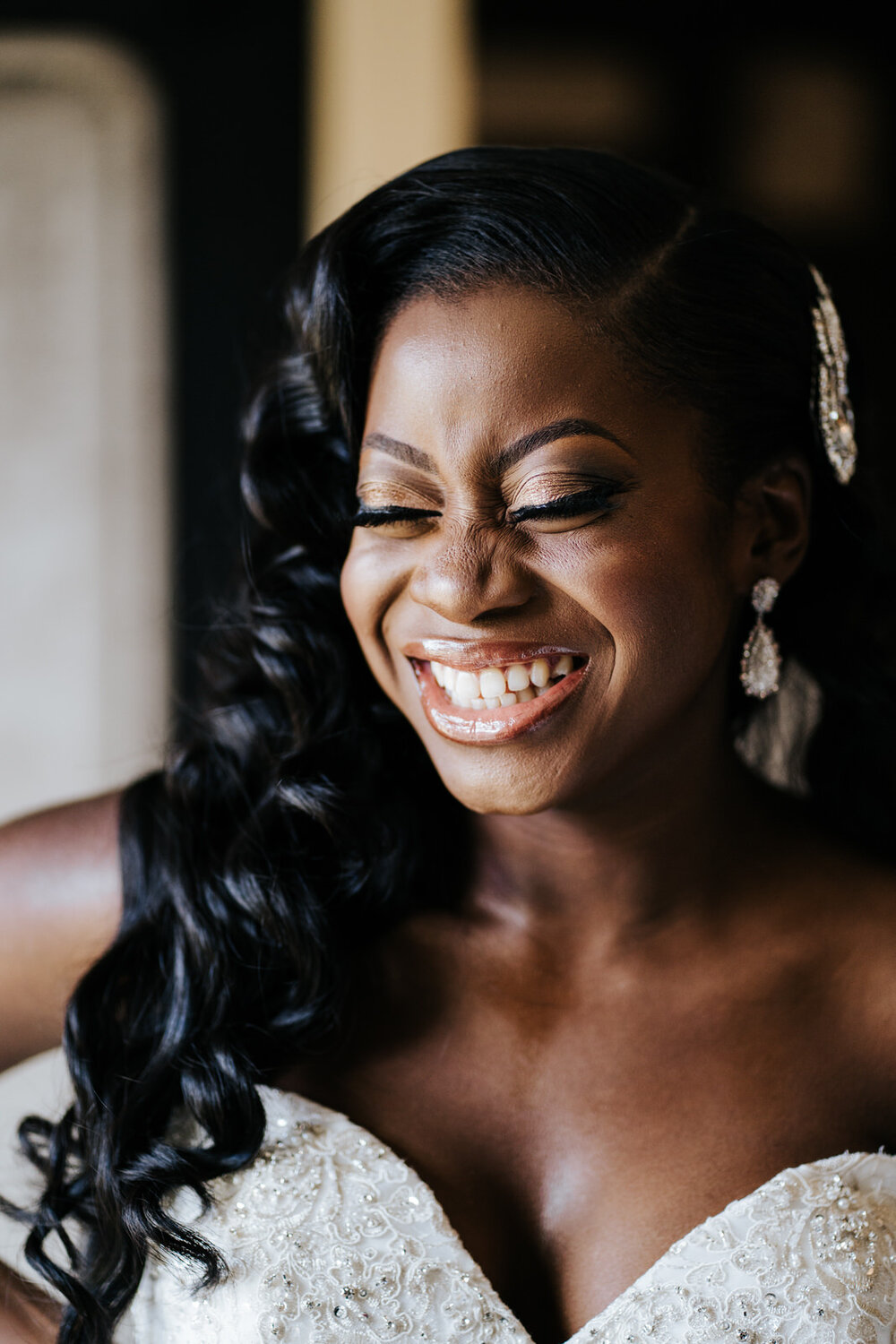Bride smiles to herself in candid photograph of her getting ready