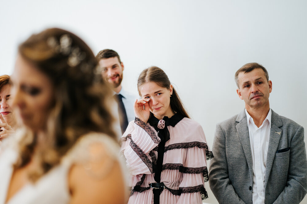 Sister of the bride cries during wedding ceremony