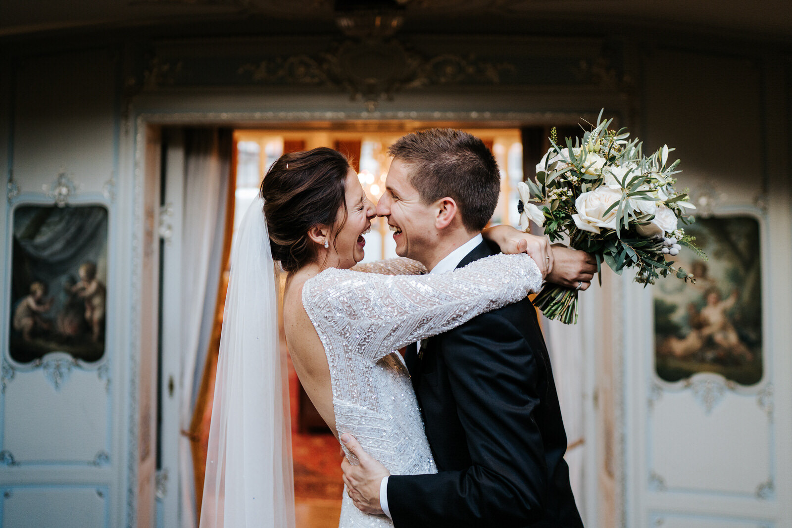 Bride and groom embrace and cannot contain their laughter