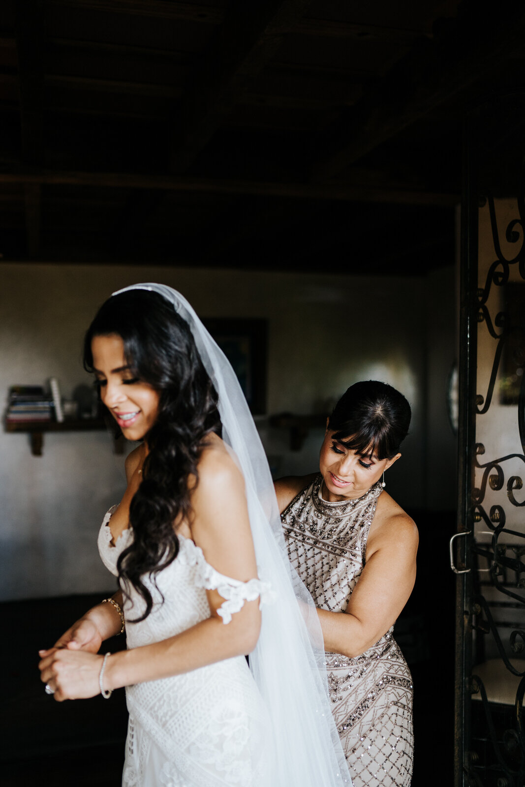 Mother of the bride helps the bride with last preparations as sh (Copy)