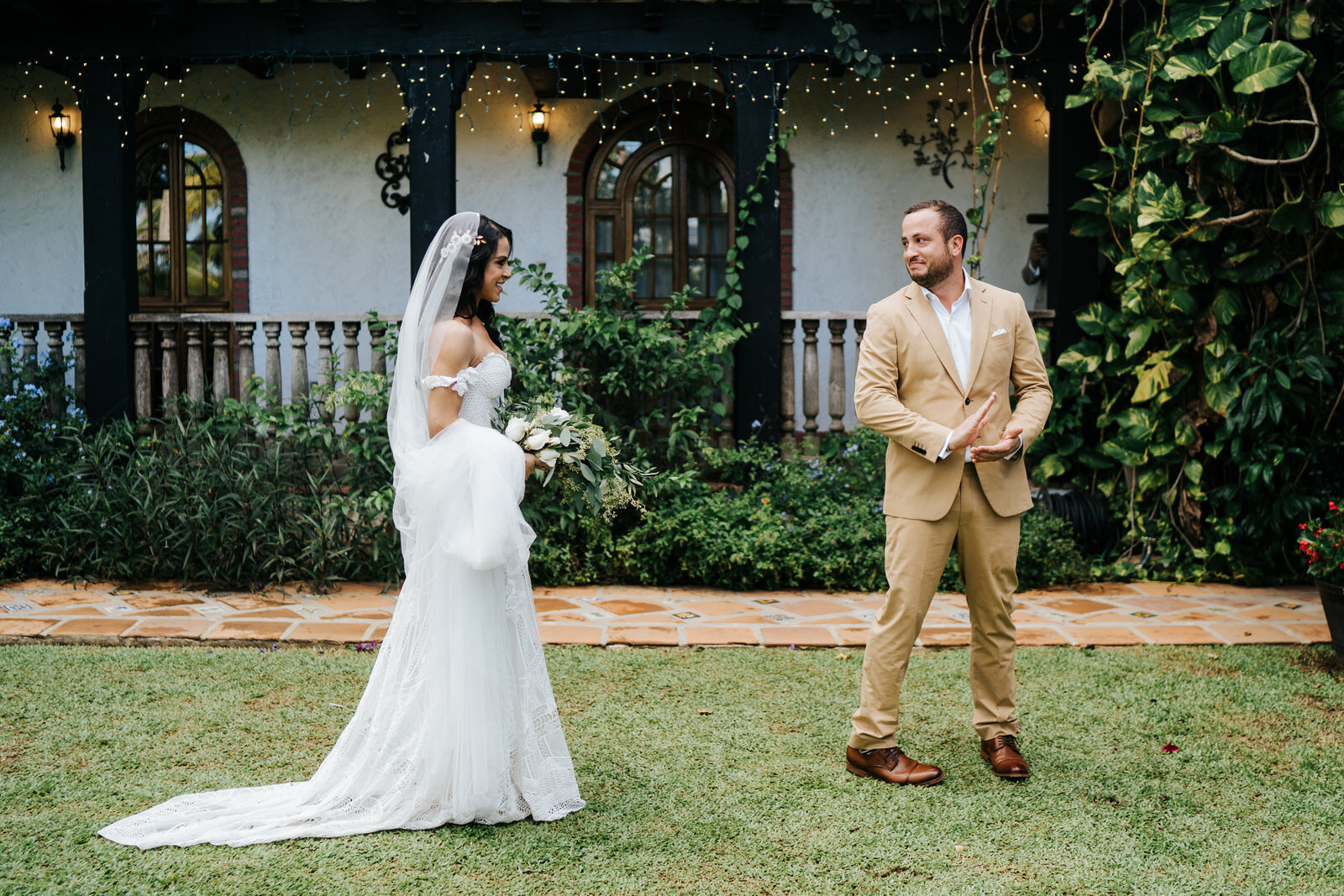 Side angle of both bride and groom in focus as groom turns aroun (Copy)