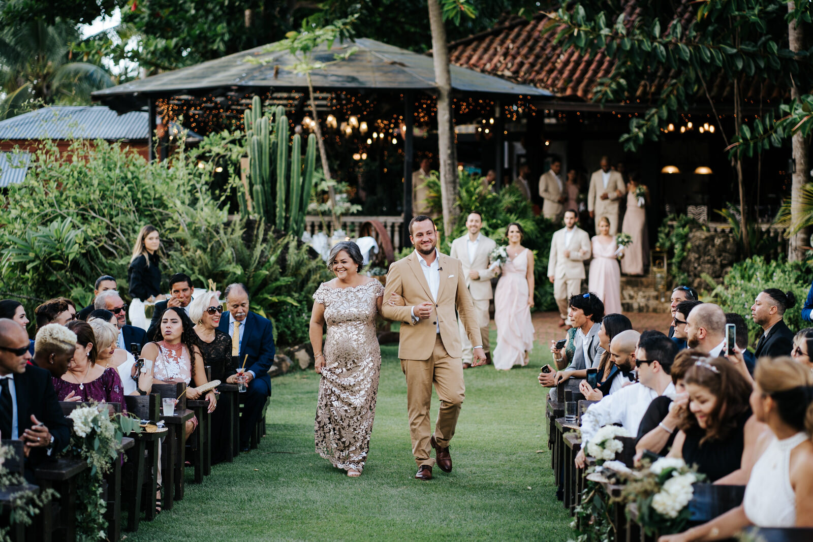 Groom and his mother walk down the aisle, hand in hand, as all t (Copy)