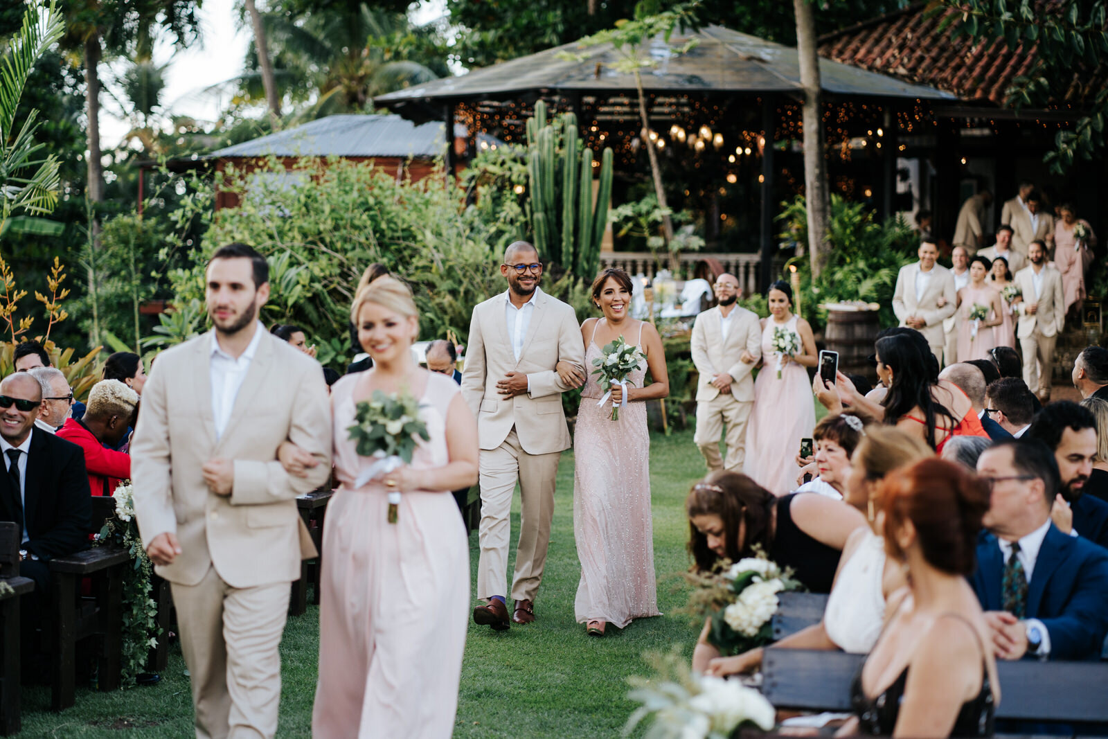 Bridesmaids and groomsmen continue the procession down the aisle (Copy)