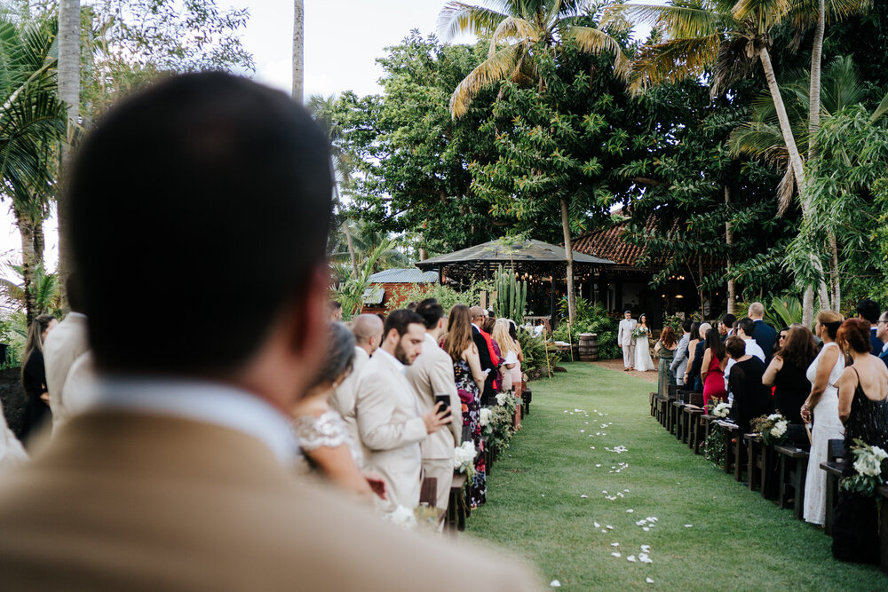 Photograph over groom's shoulder as he looks, out of focus in lo (Copy)