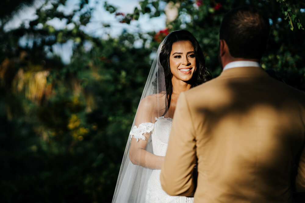 Bride stands in beautiful, dappled sunlight as she listens to gr (Copy)