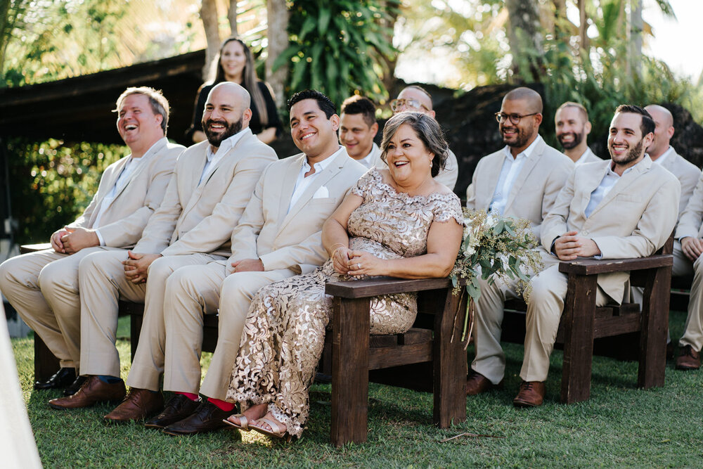 Mother of the groom and his groomsmen smile as they look at the  (Copy)