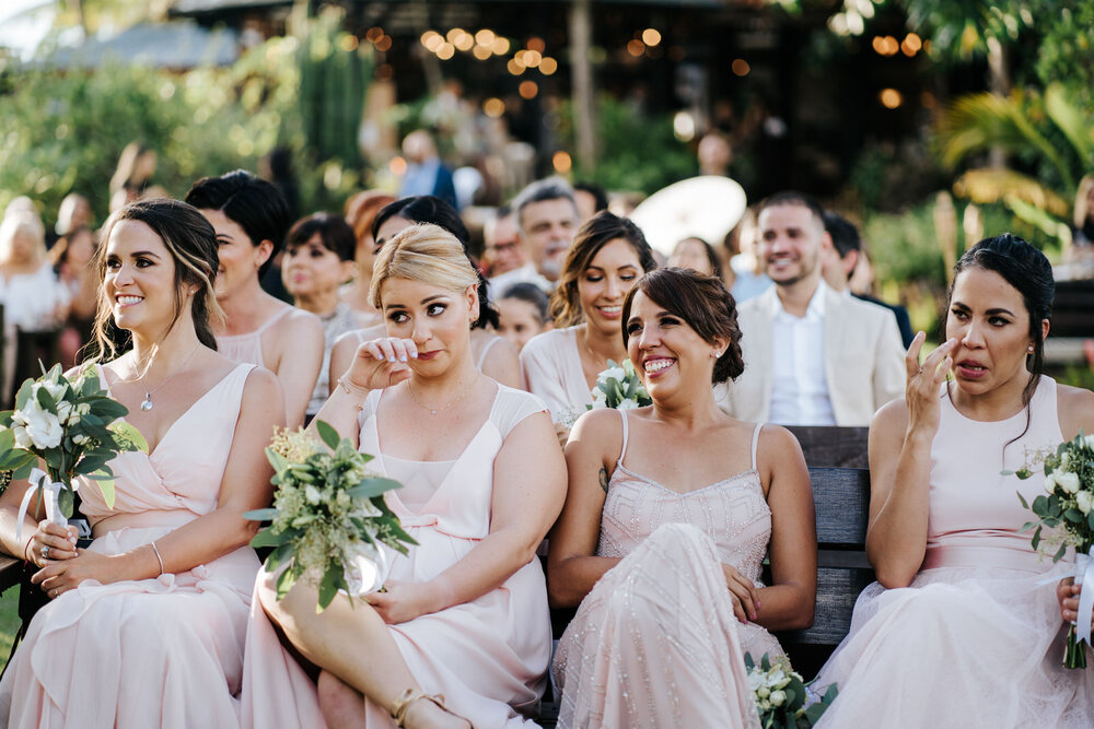 Bridesmaids smile and cry as they look at the couple during the  (Copy)