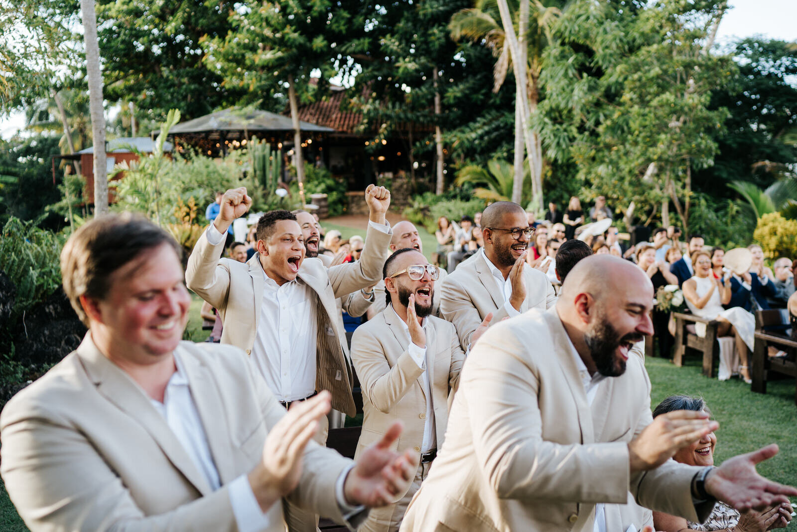 Groomsmen stand up and cheer as the groom finishes reading his p (Copy)