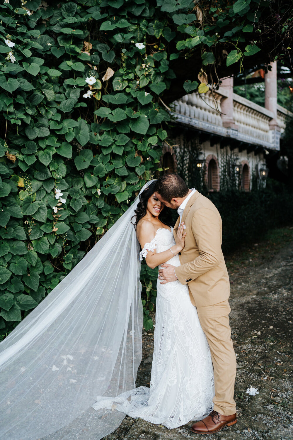 Bride and groom pose in front of lush greenery at Puerto Rico Ha (Copy)