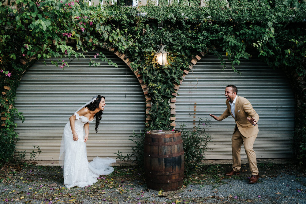Bride and groom take playful photograph as they look at each and (Copy)