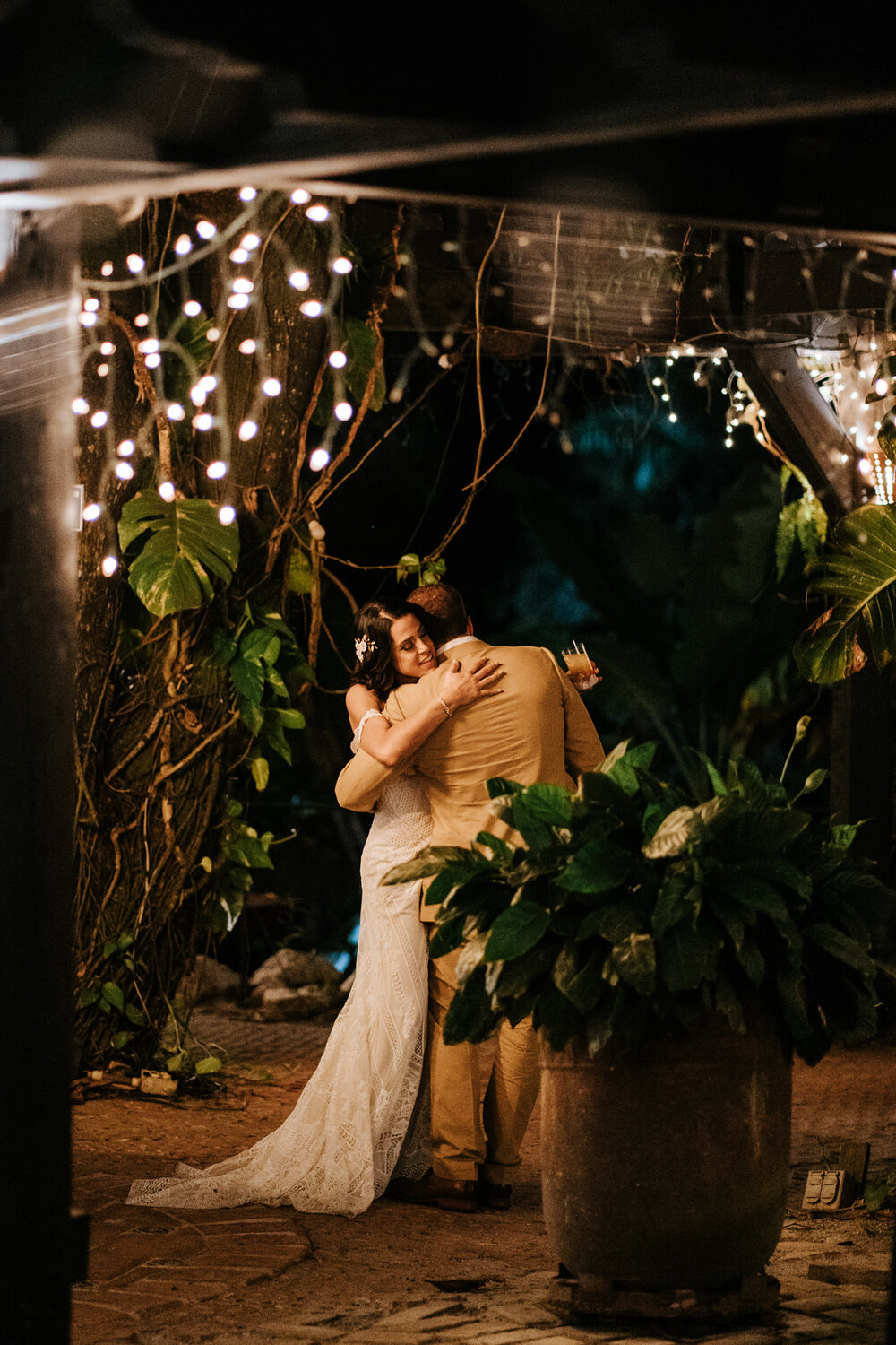 Bride and groom go off on their own and share a tender hug under (Copy)