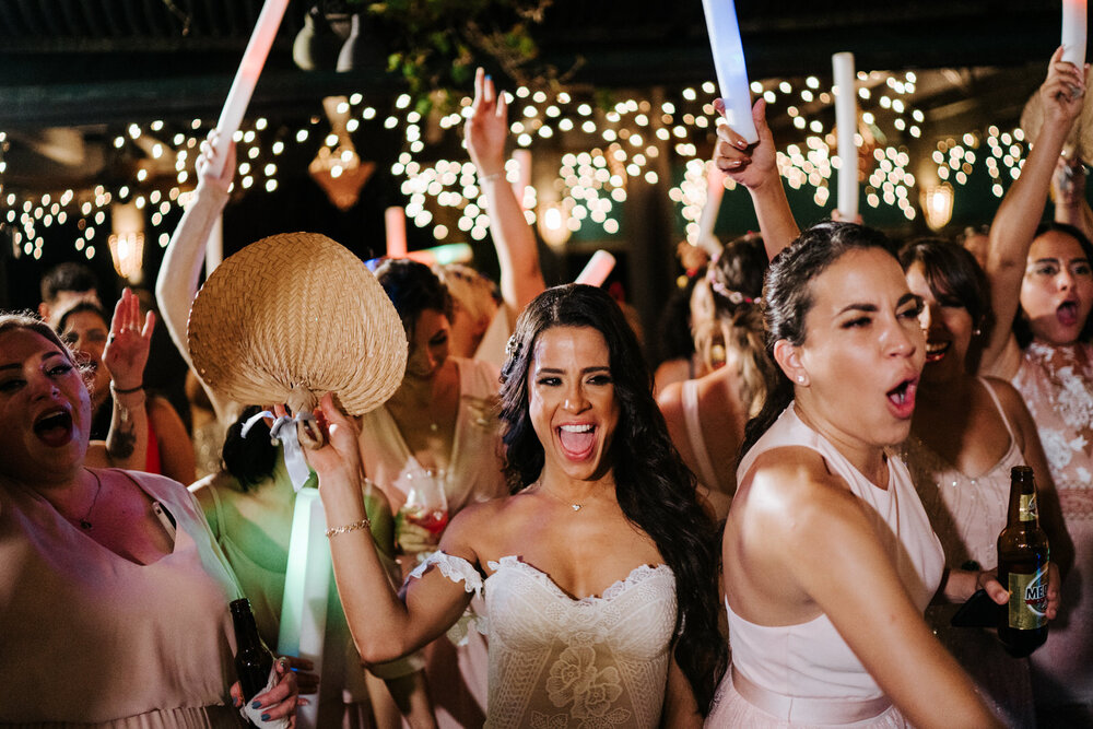 Bride and her girlfriends throw hands into the air as party take (Copy)