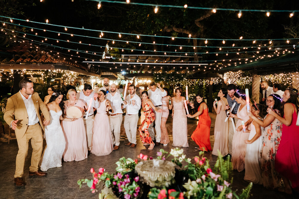 Conga line of all weddings guests dancing under fairy lights as  (Copy)