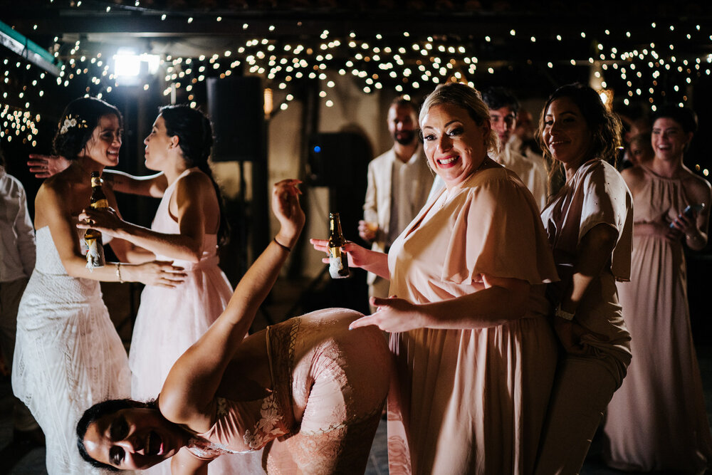 Chaotic photograph of one of the bridesmaids twerking on another (Copy)
