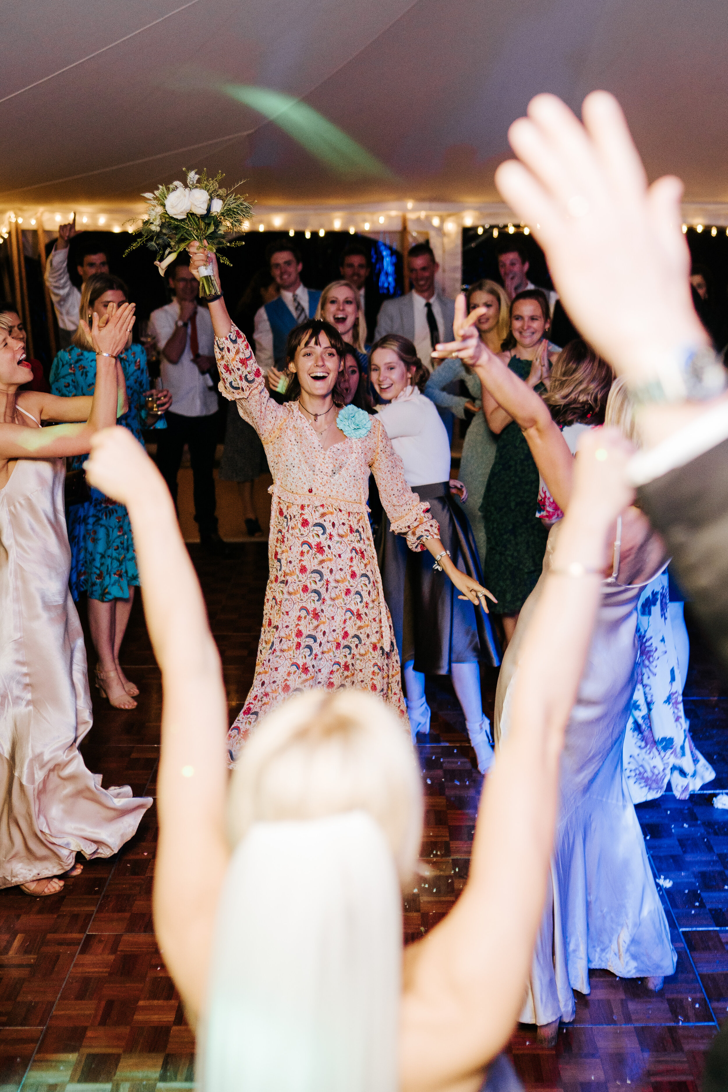 Guest emerges victorious and catches bouquet that bride threw