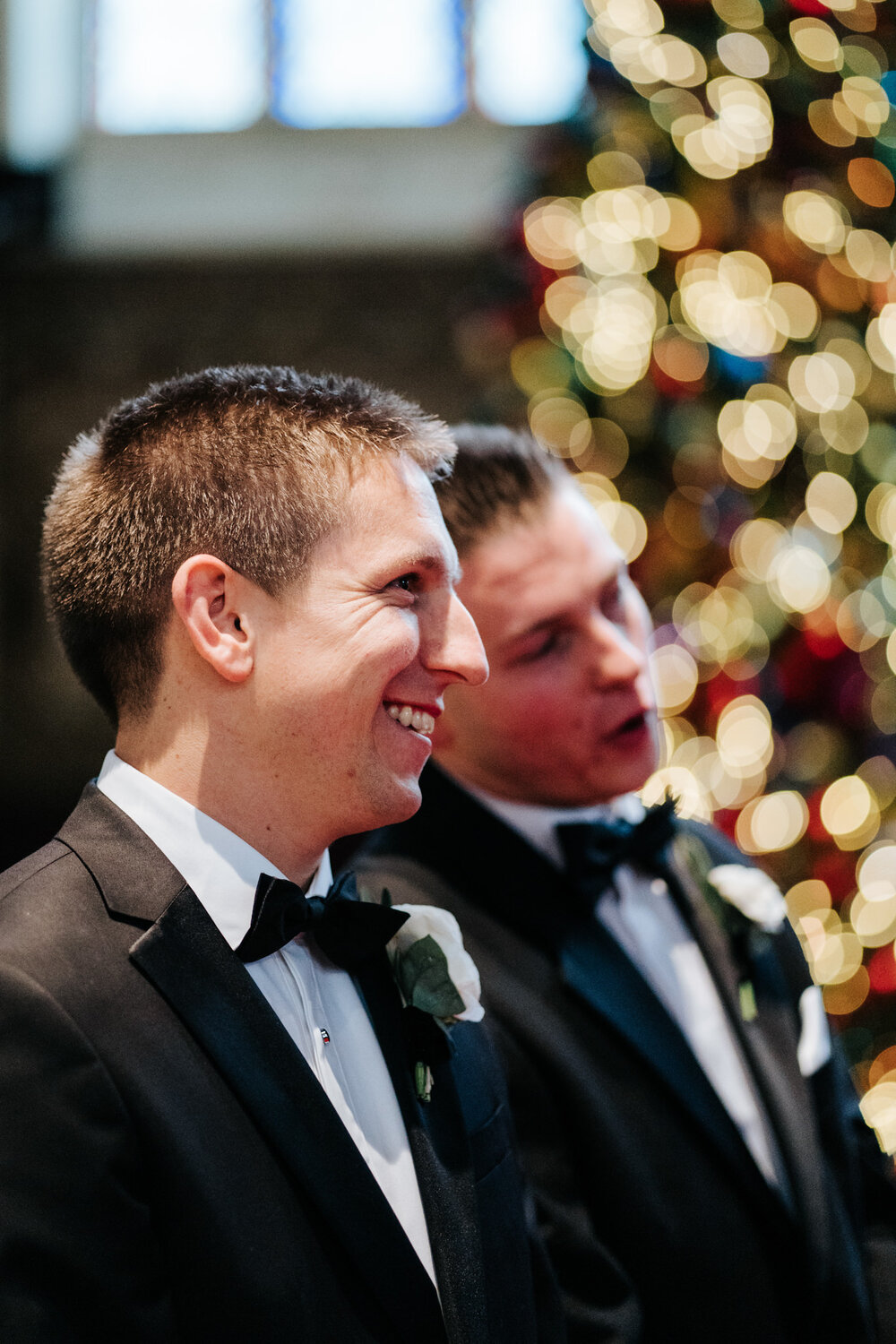 Groom and his best man react to seeing the bride walk down the aisle at St Paul's Knightsbridge London wedding