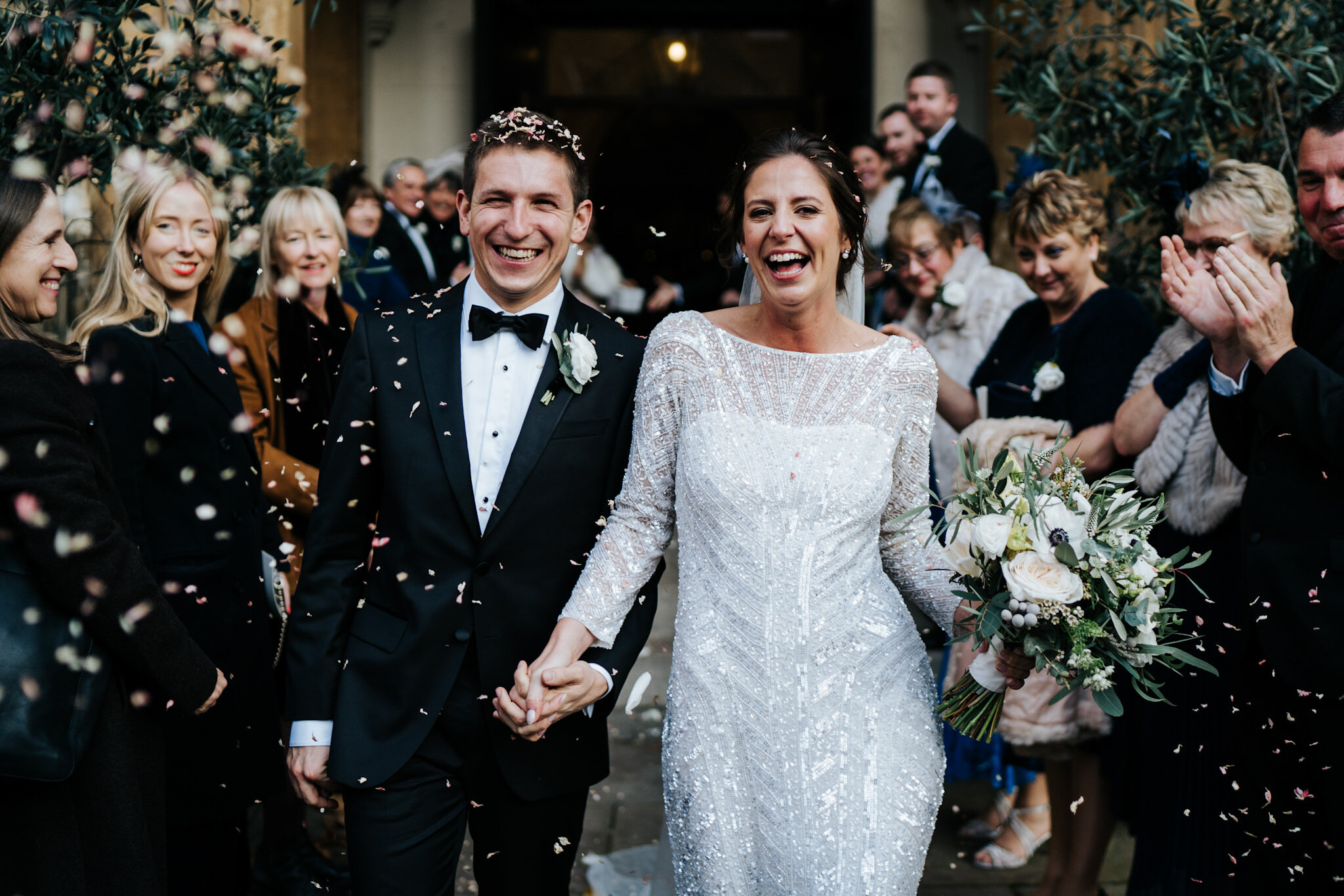 Bride and groom walk out of St Pauls Knightsbridge after wedding ceremony as guests throw confetti at them