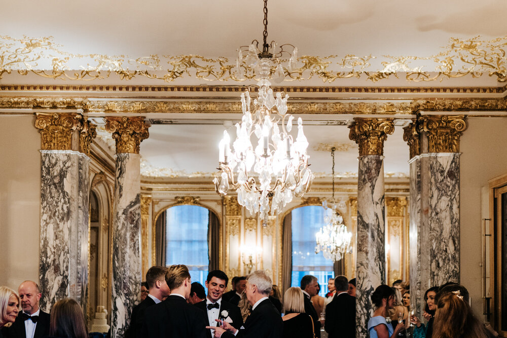 Atmospheric photograph of guests mingling during Savile Club London wedding