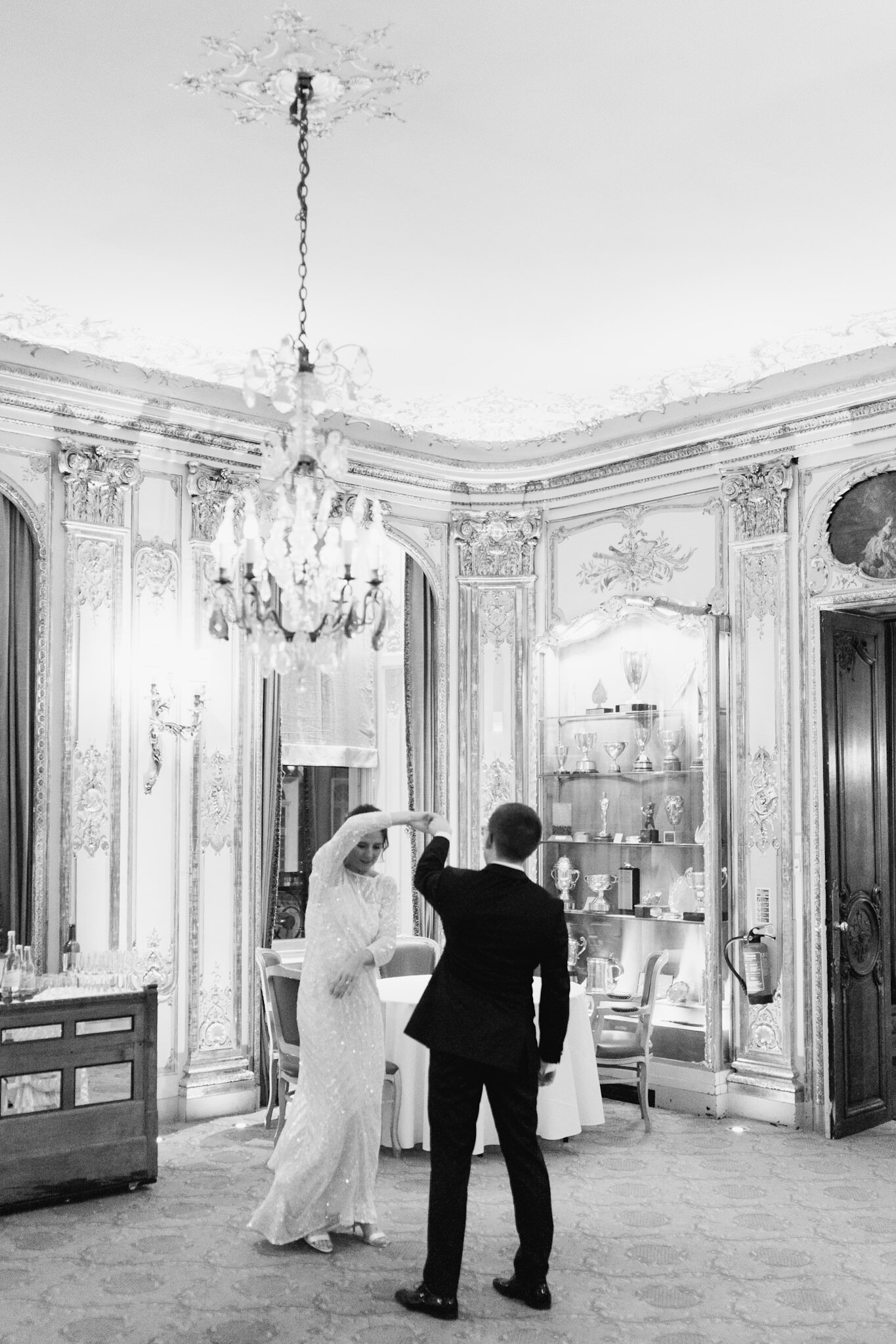 Black and white photograph of the bride and groom practicing their first dance at Savile Club London