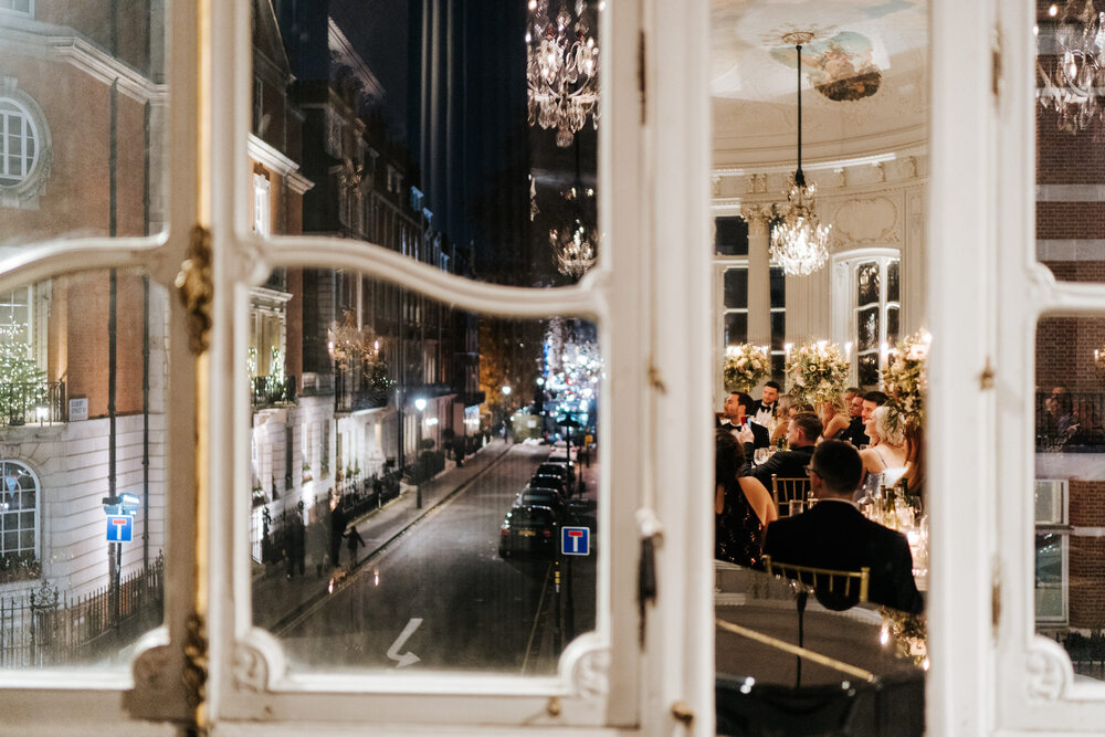 Photograph of London in the winter as the wedding breakfast reflects in one of the window panes
