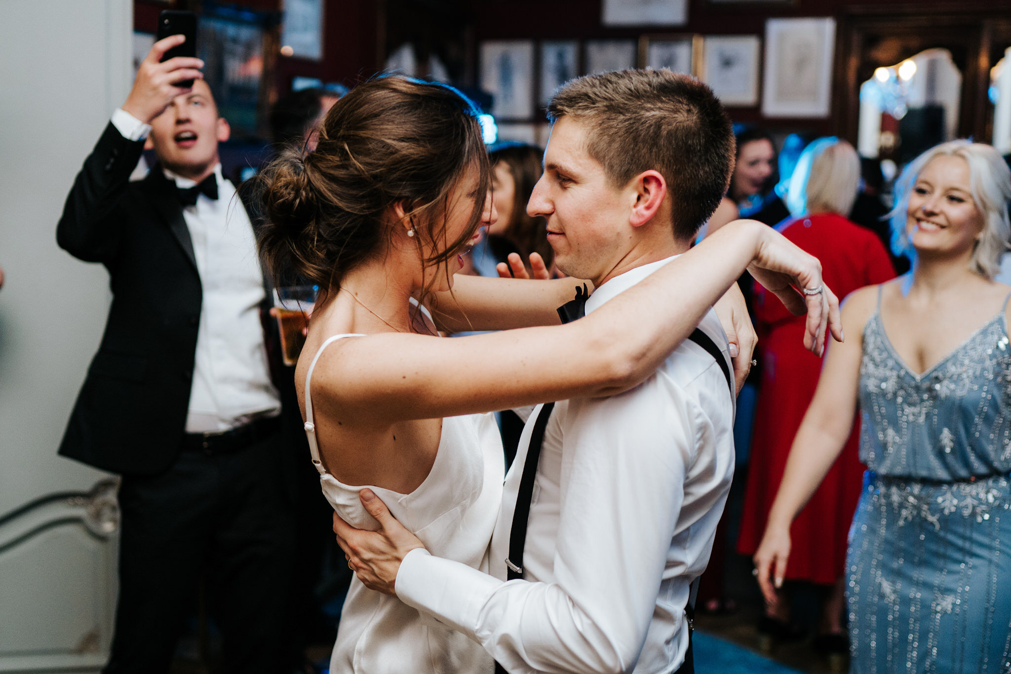 Bride and groom look at each other as they dance closely