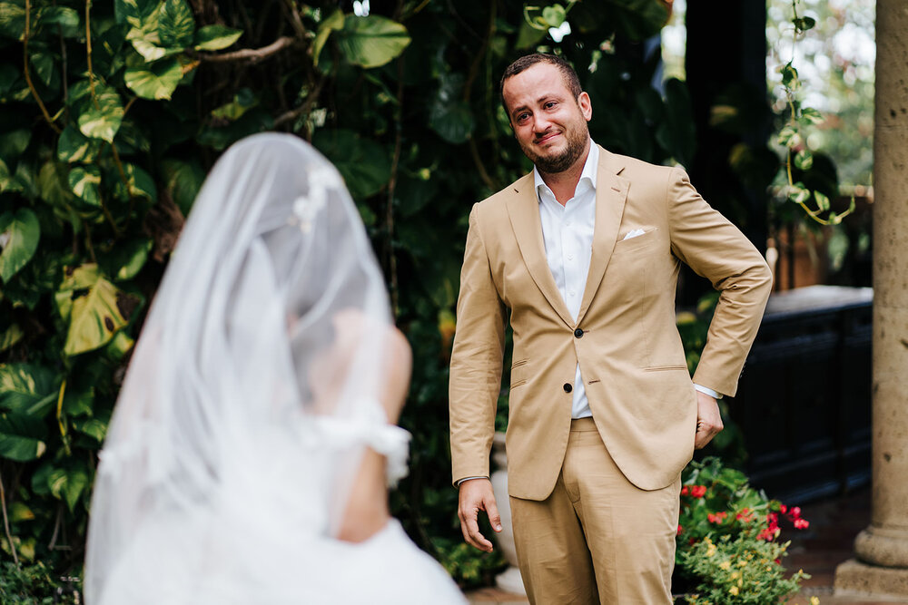 Groom holds back tears in Puerto Rican Ranch Wedding as he sees his bride to be in her dress for the very first time