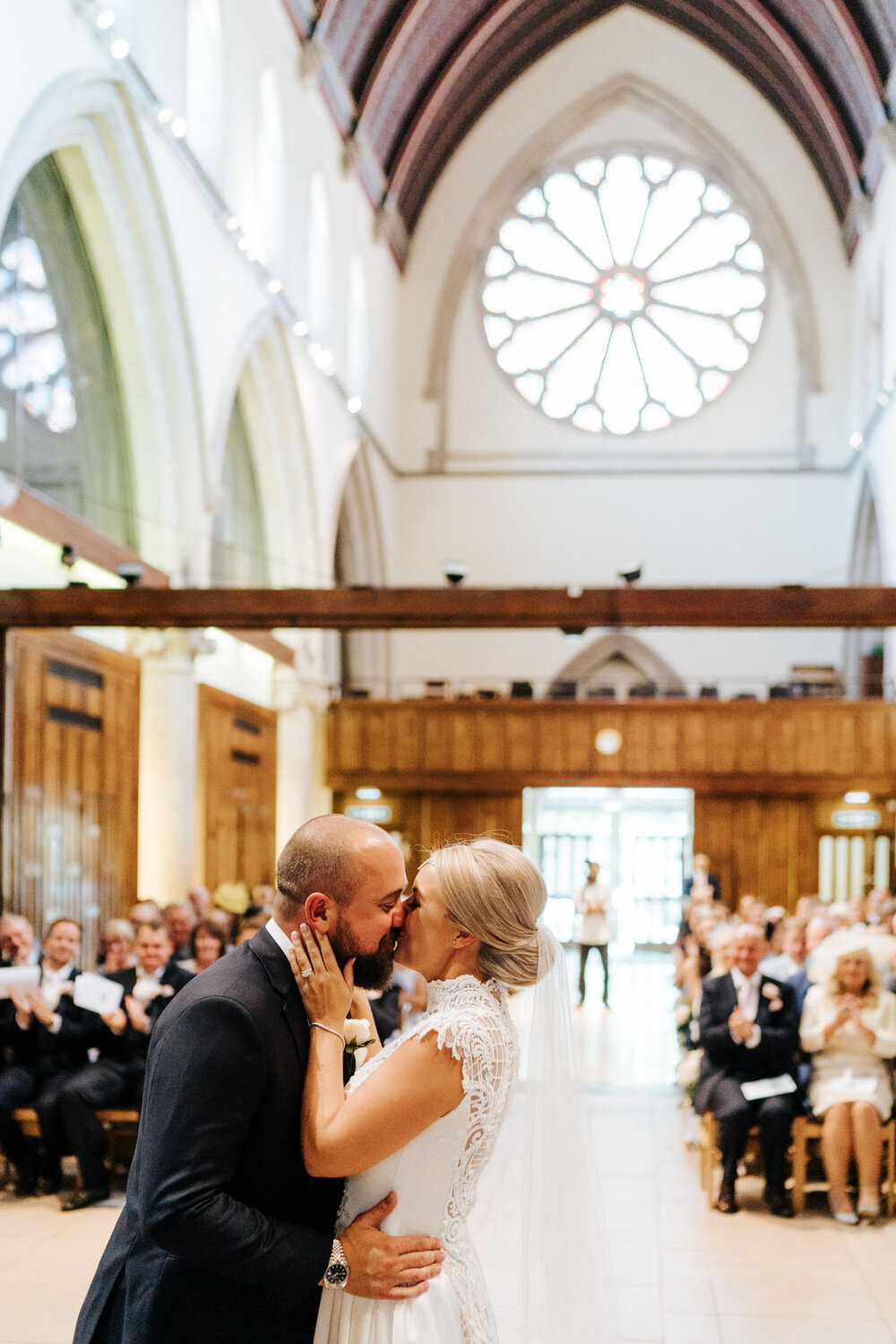 Bride and groom share their first kiss during service at St Matthias Church in Richmond