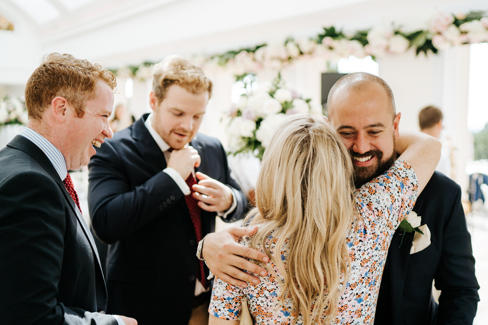 Guests hug the groom at Pembroke Lodge in Richmond
