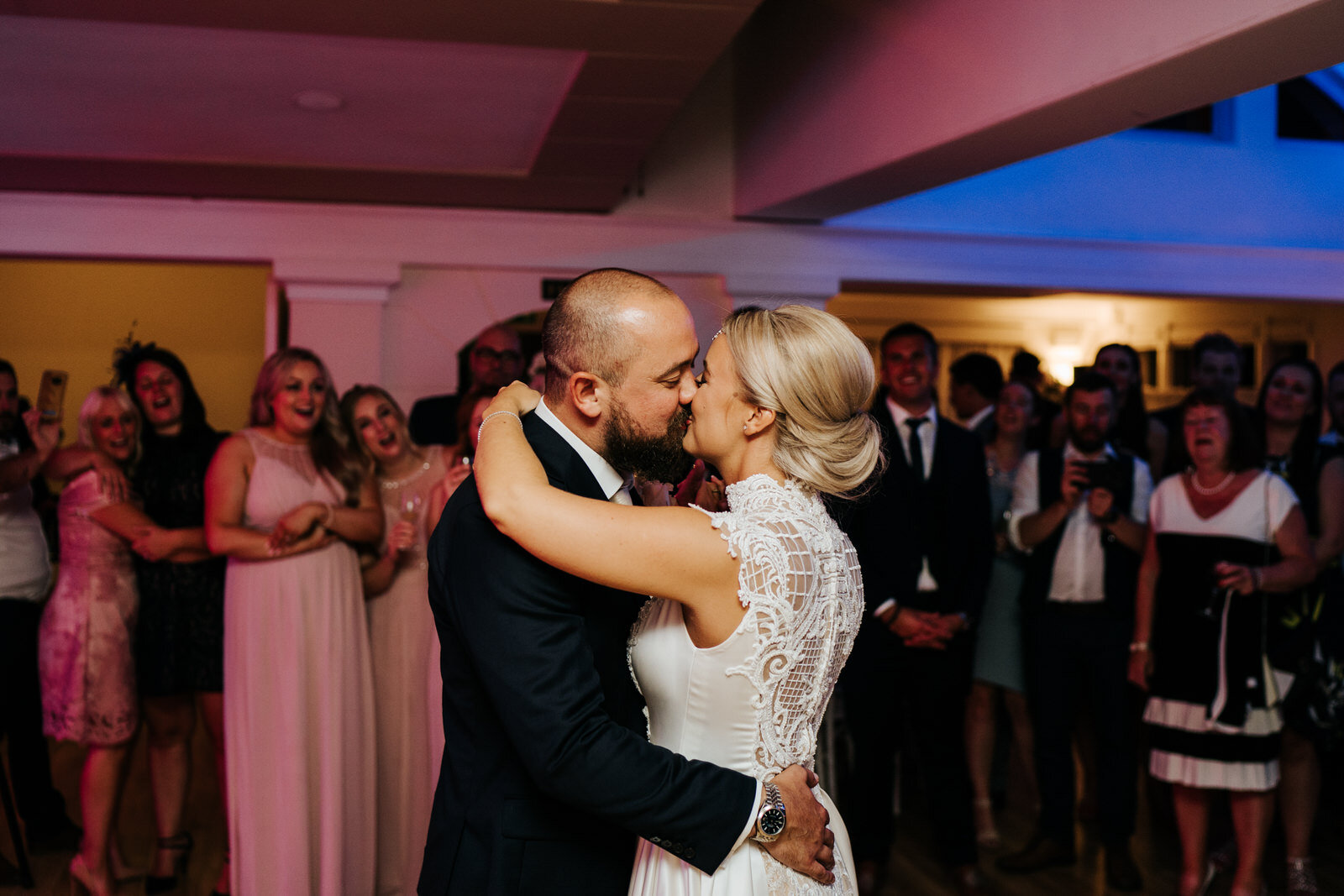 Bride and groom embrace and have their first dance at Pembroke Lodge in Richmond