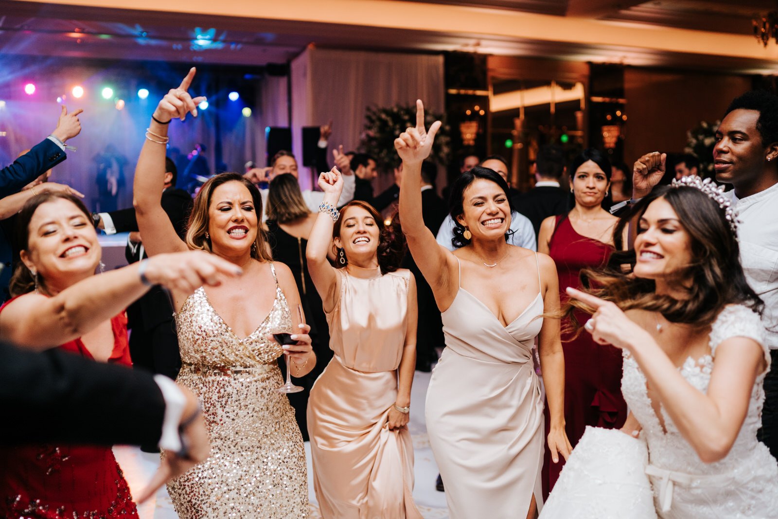 Bride and four of her friends party on the dancefloor with hands in the air during Puerto Rico wedding at Vanderbilt Hotel