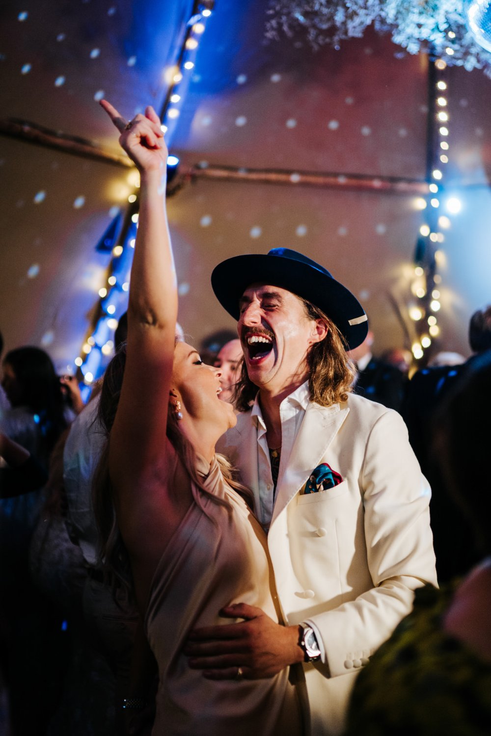 Two guests party on tipi tent dancefloor at Secret Garden Twickenham wedding
