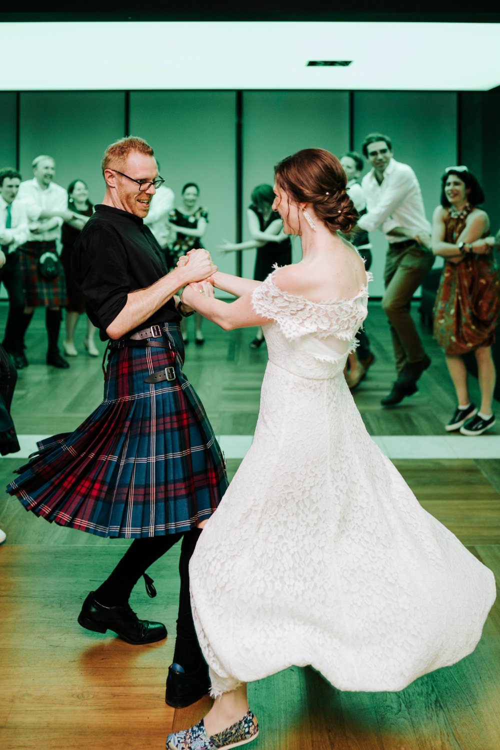 Bride and groom do the Ceilidh dance at Barbican Conservatory wedding 