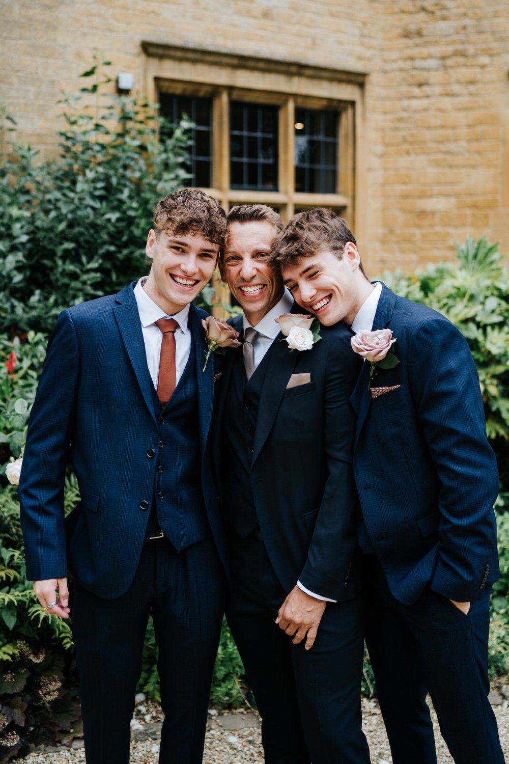 Groom poses with his two twin sons outside Foxhill Manor before departing for church wedding