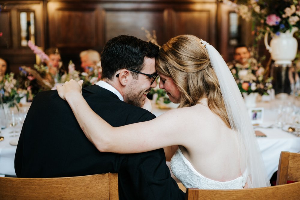 Bride and groom lean each other's foreheads against each other in intimate moment at Jesus College wedding in Cambridge
