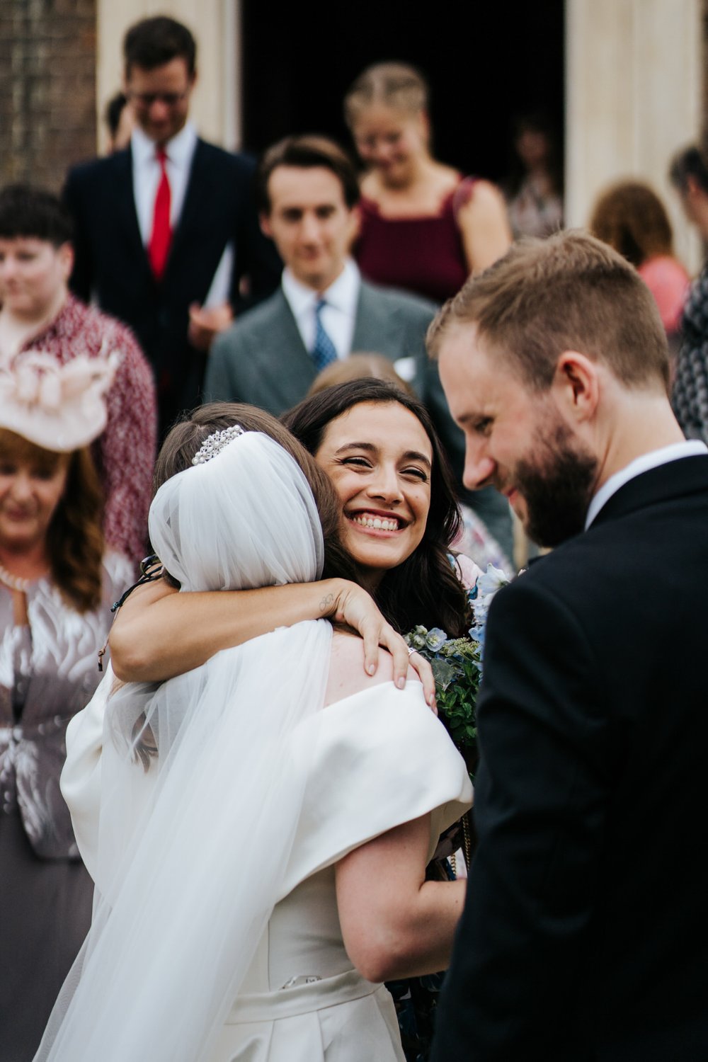Guest hugs bride and smiles right after wedding ceremony at Little Banqueting House in London