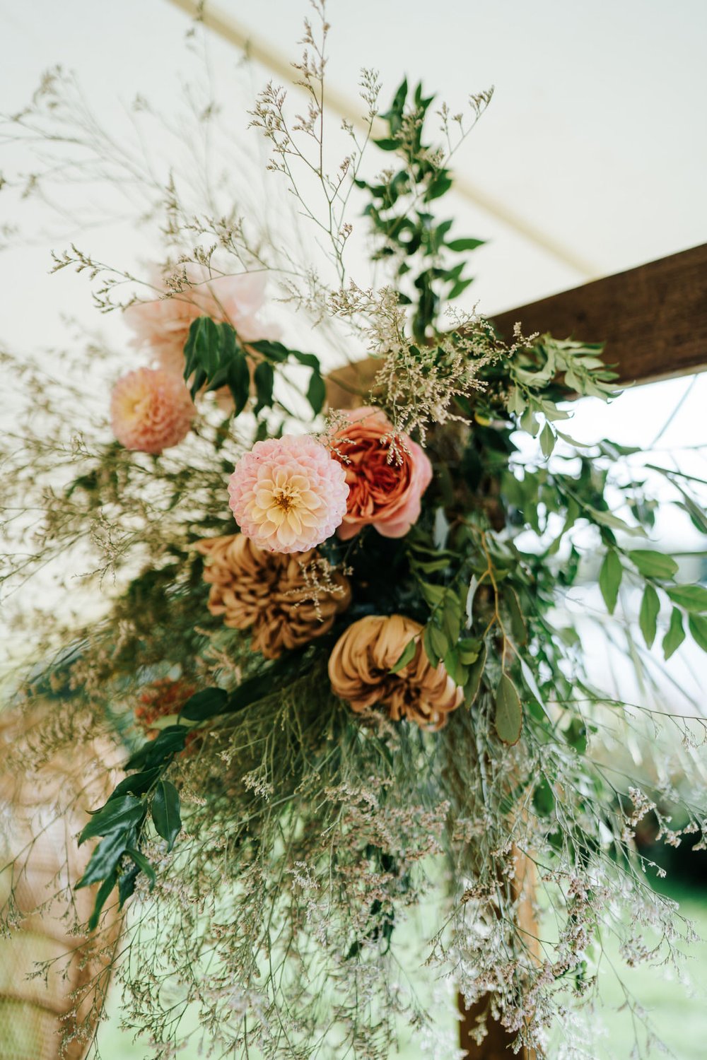 Close-up of wedding flower arch by Leigh Chappell Flowers during Secret River Garden Twickenham wedding