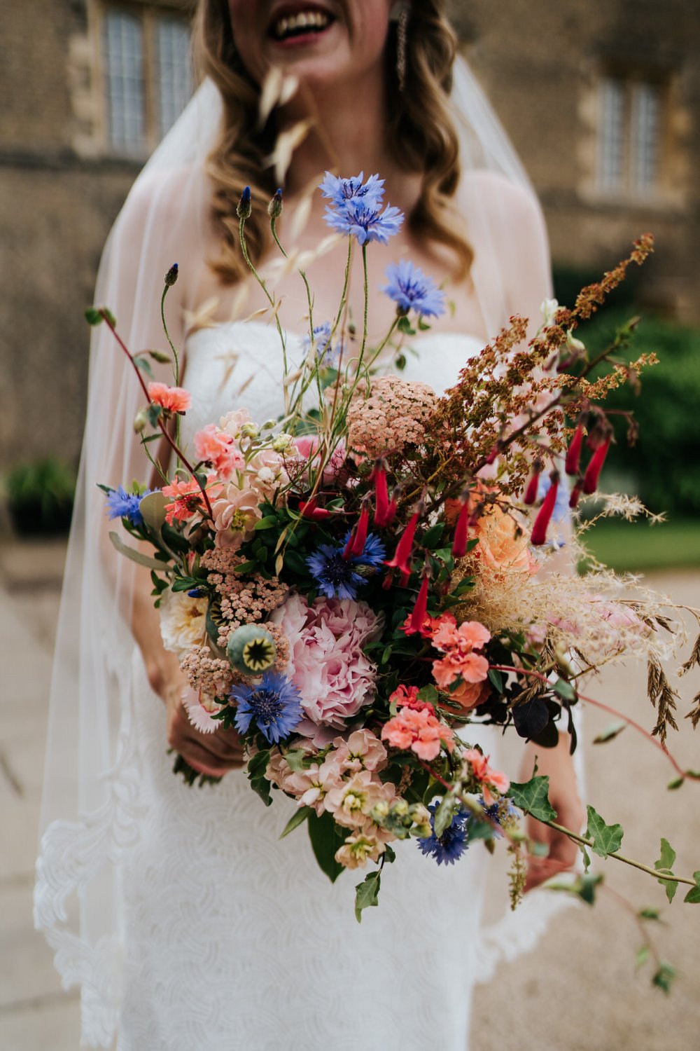 Close-up of bride's wild and colourful flowers by Wild Rosamund during Jesus College, Cambridge wedding